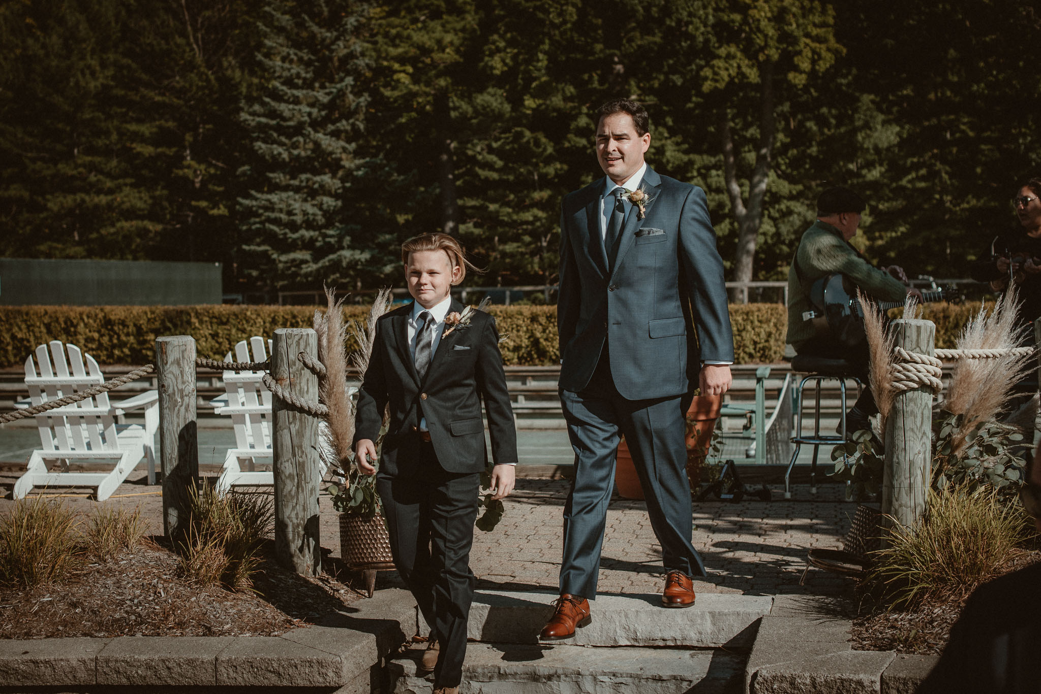 The groom's son and best friend as best men walking down the isle.