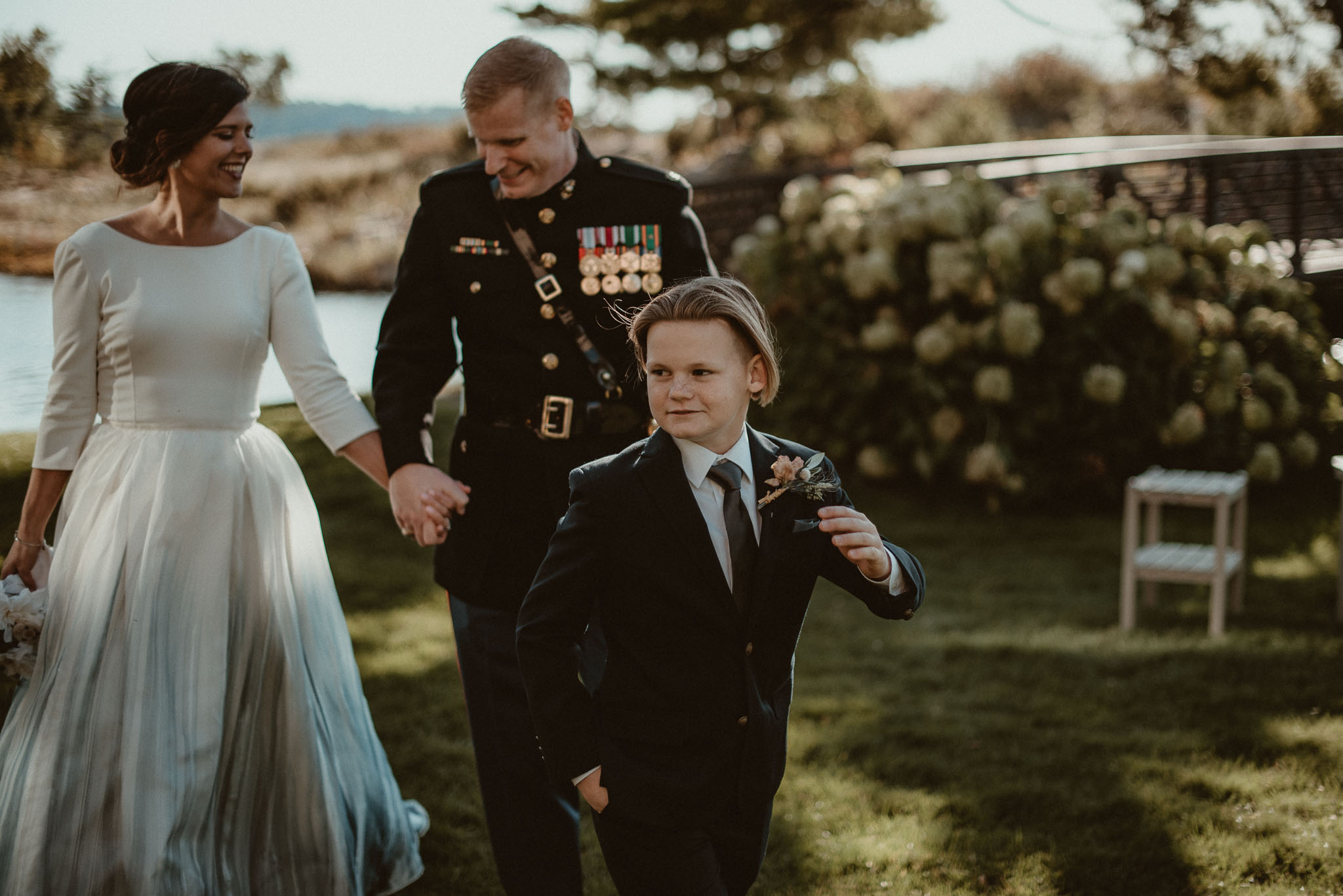 Bride and Groom walking with their son ahead of them.
