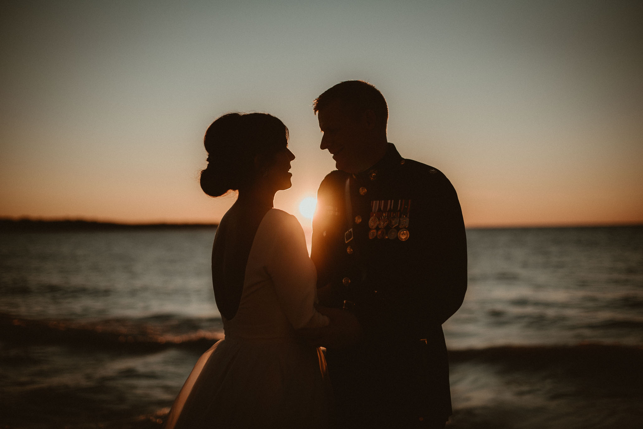 Sunset between bride and groom in silhouette.