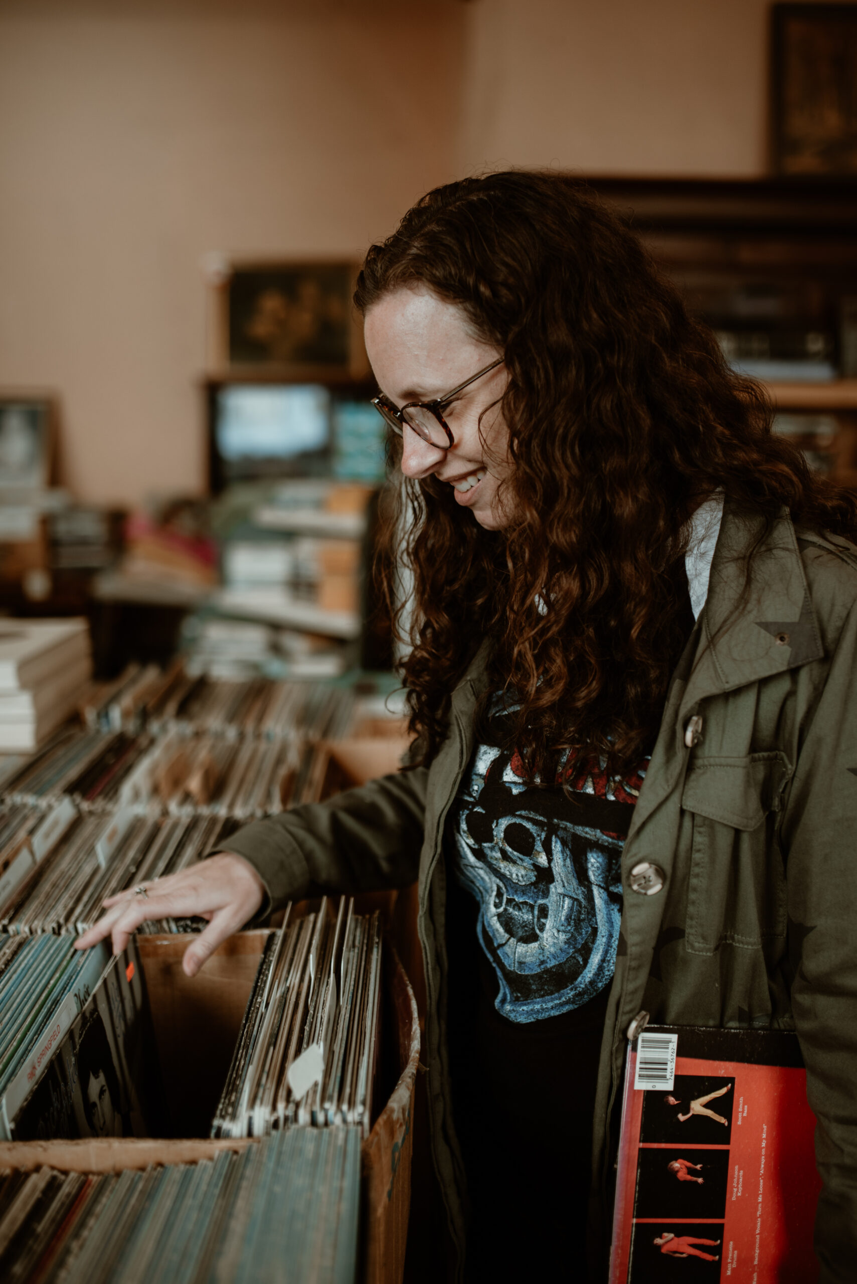 Photographer Shonda Michelson looking through vinyl records at a thrift store.