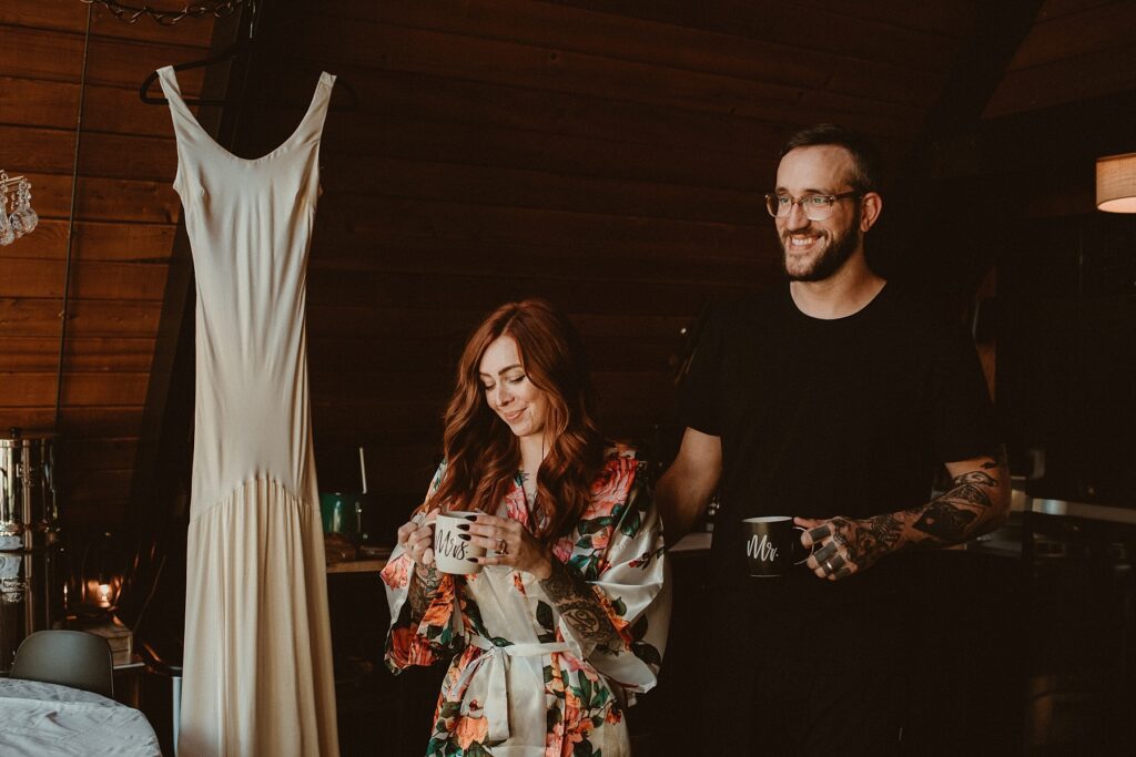 Couple walking with coffee in hands to enjoy a slow start to their elopement day.