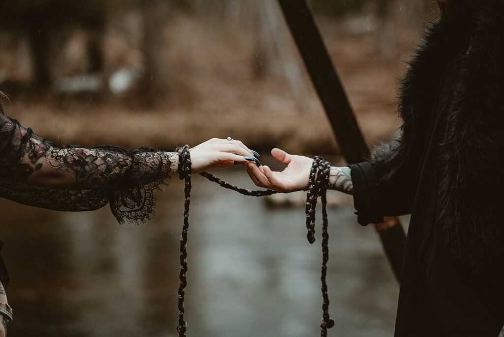 Close up of the couples hands during handfasting.