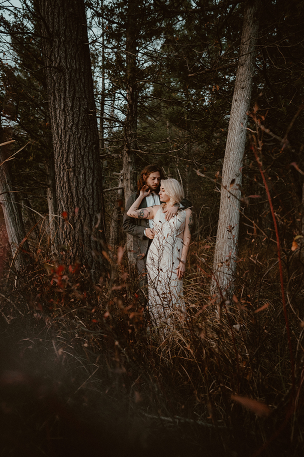 Bride & groom portrait in the woods at sunset.