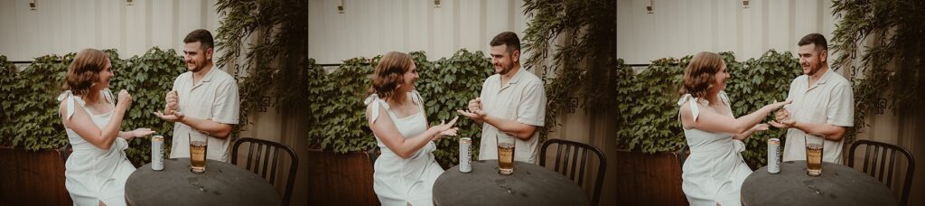 Couple having a drink and playing rock, paper, scissors.