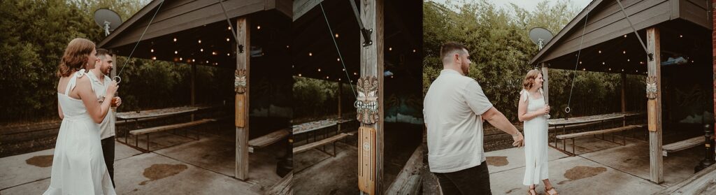 Couple sharing laughs and a drink while playing ring toss game at a bar.