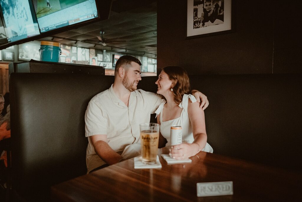 Couple sitting in VIP booth at their favorite bar.