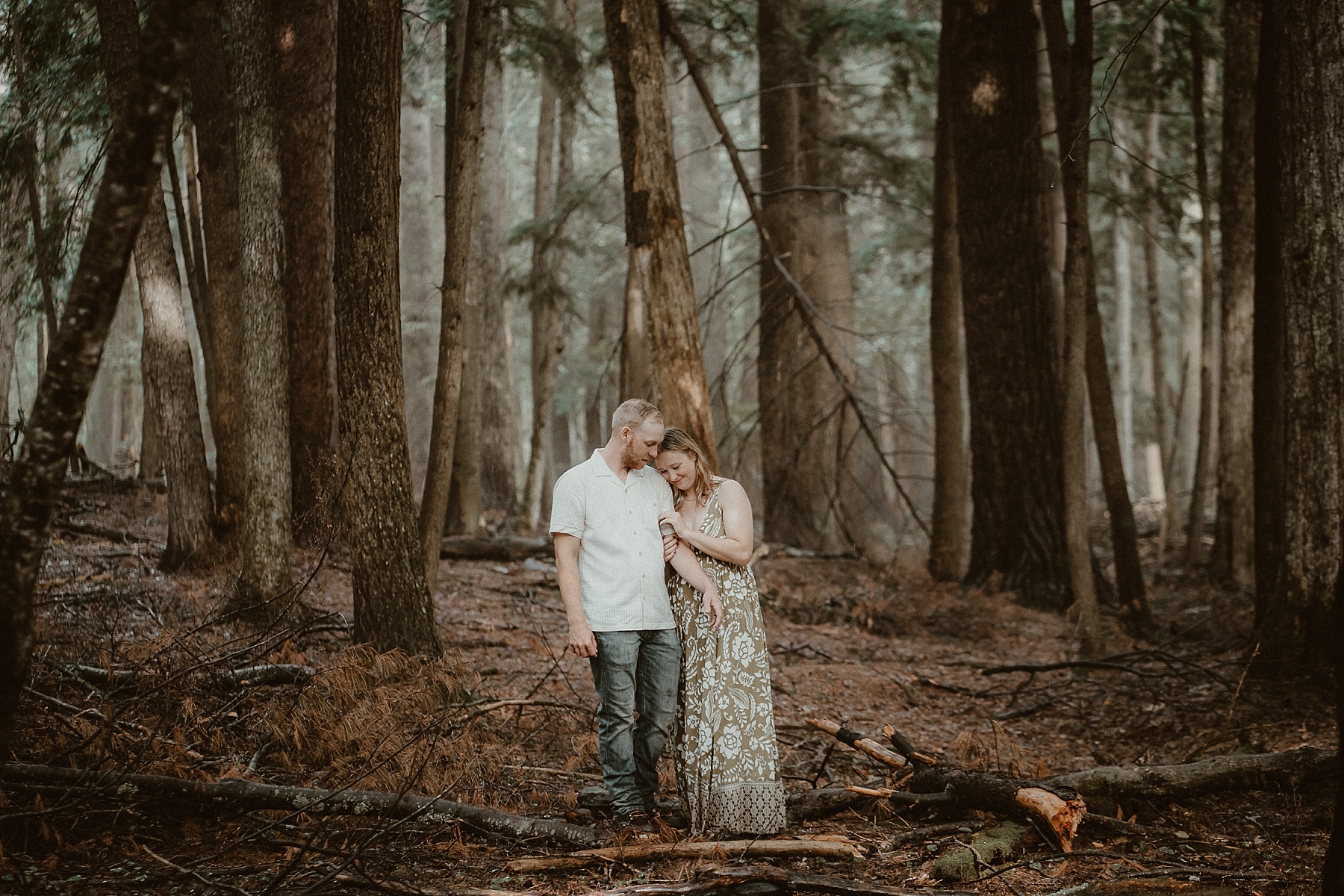 Couple standing together in the woods