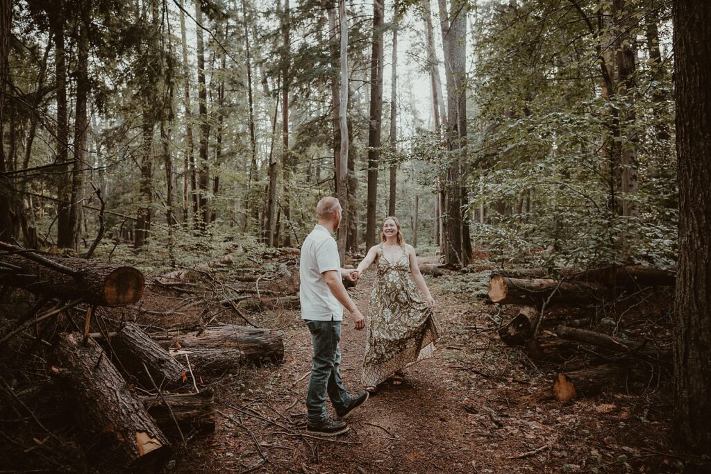 Couple being playful with each other in the woods.