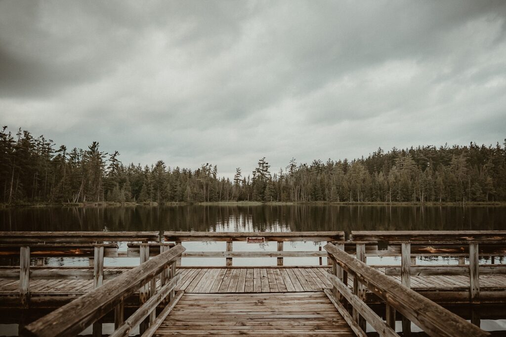 Glory Lake dock with rain clouds over the lake.