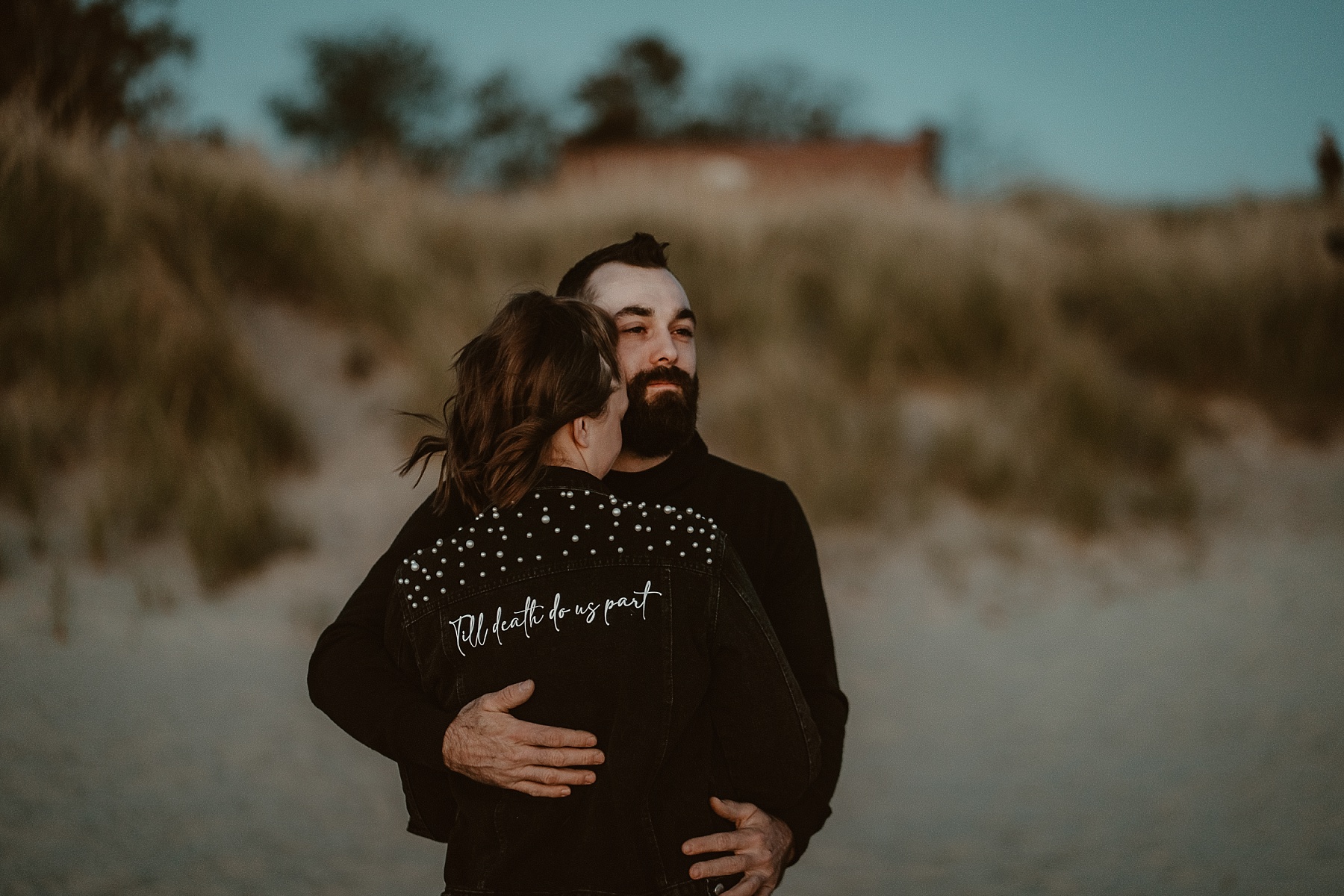 Guy holding his fiancé during a Lake Michigan sunset.