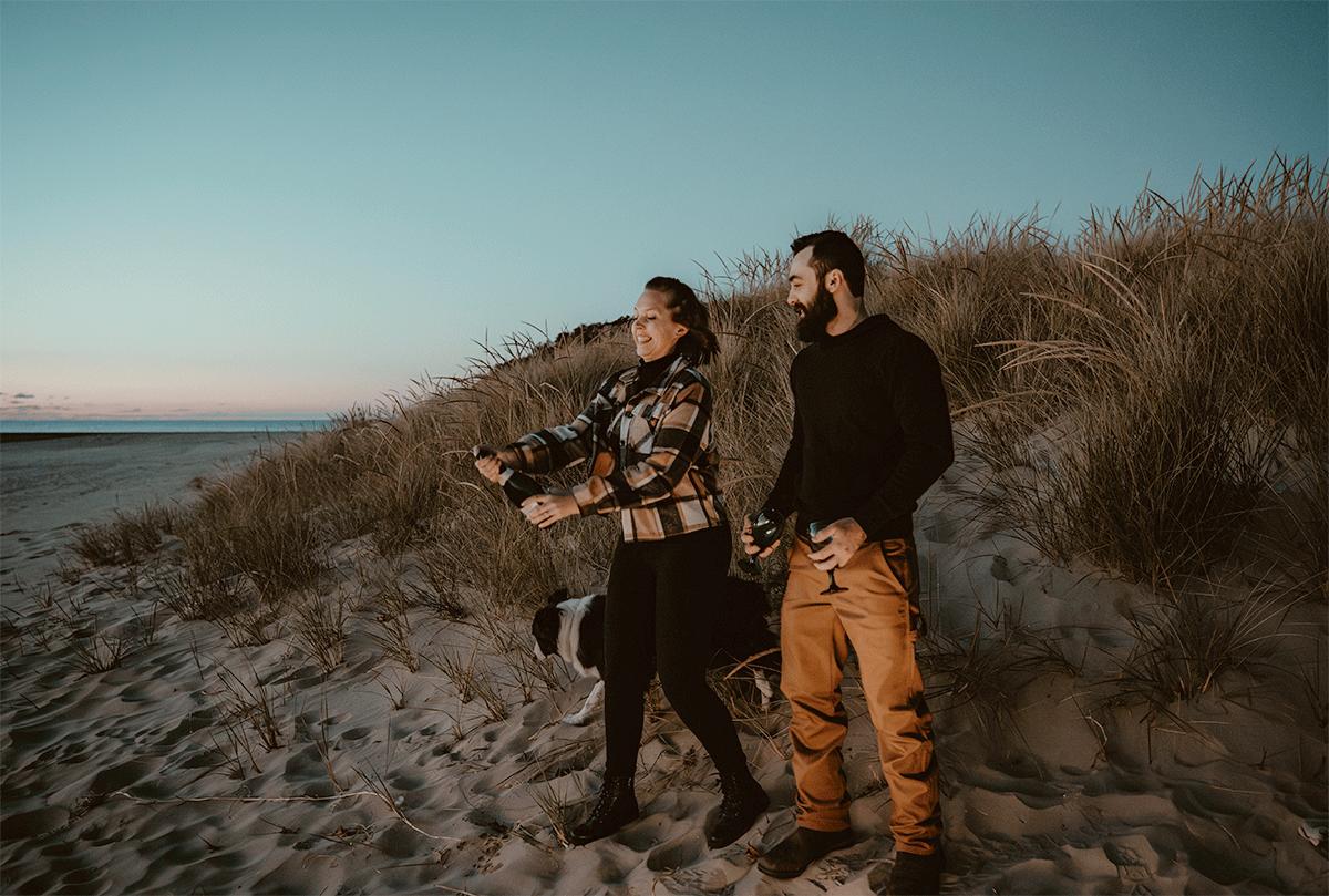 GIF of couple popping champaign at sunset during engagement session on Lake Michigan.