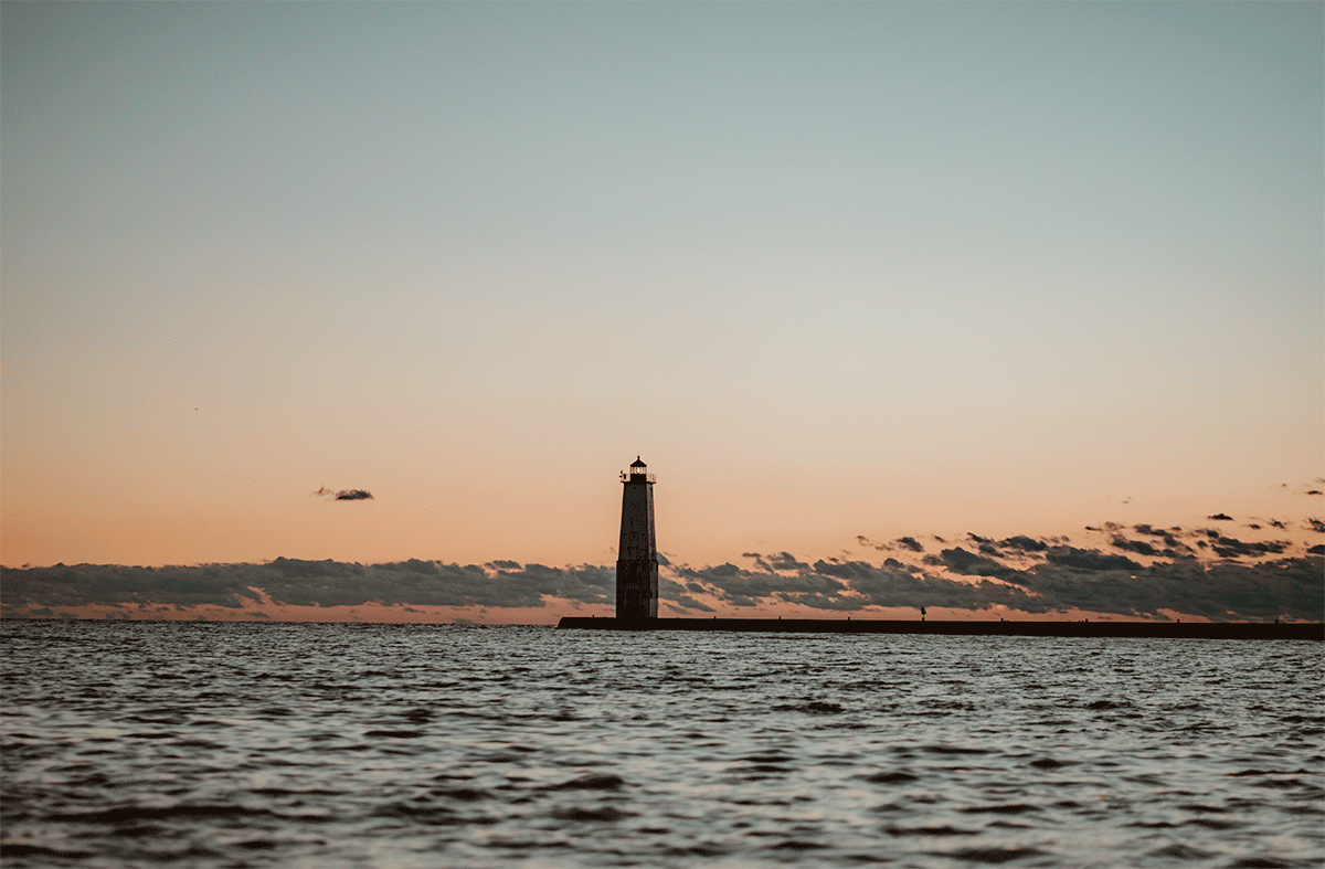 A GIF of Frankfort Light glowing in the warm sunset light along the north breakwater