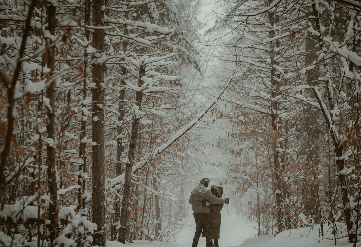 GIF of couple dancing the heavy snow fall during engagement session at Hartwick Pines State Park in Grayling MI