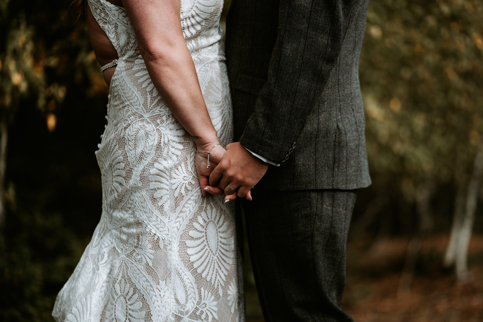 Close up of bride and groom holding hands during their Upper Peninsula elopement.