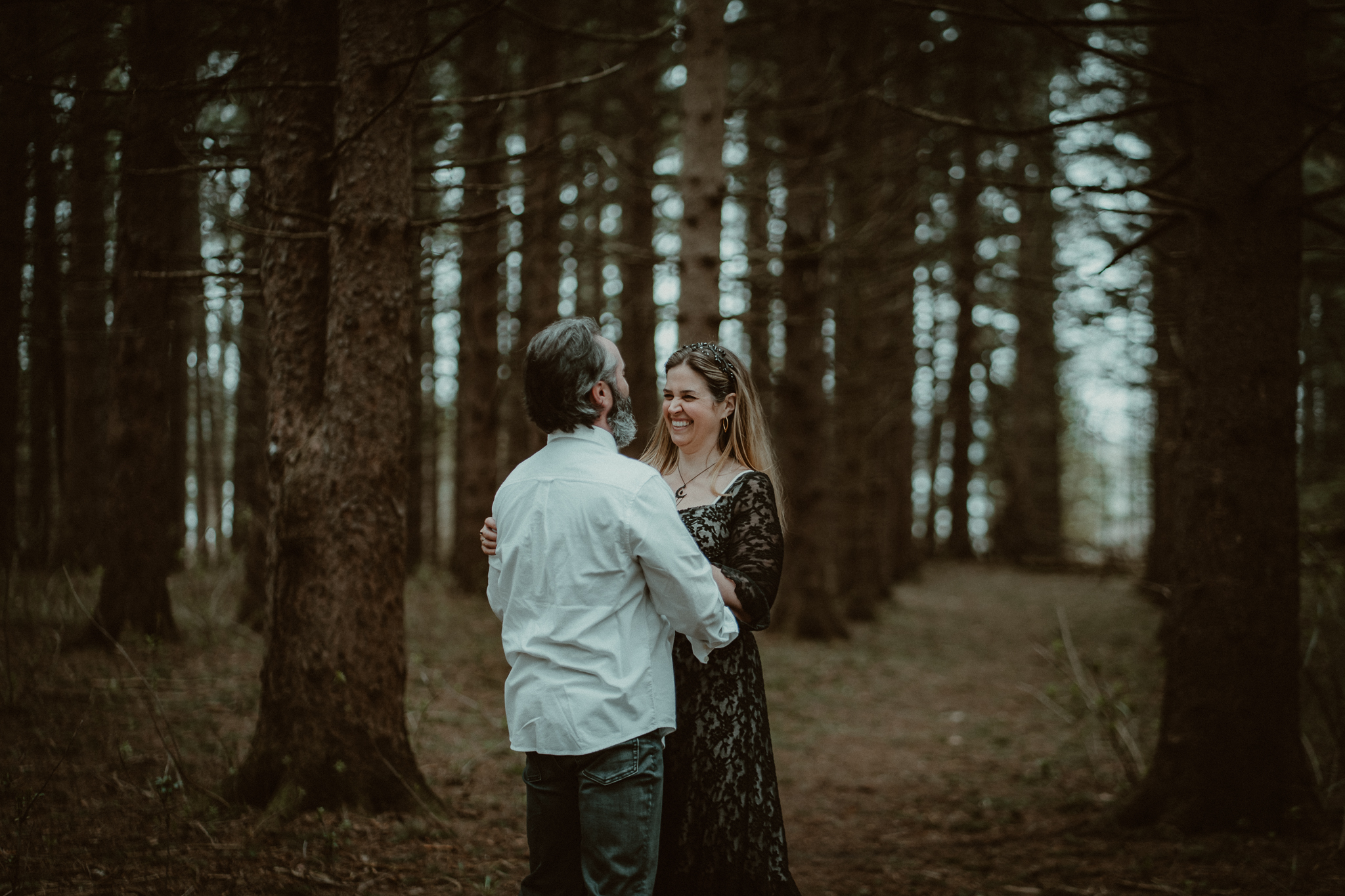 Couple laughing together in the forest of Northern Michigan